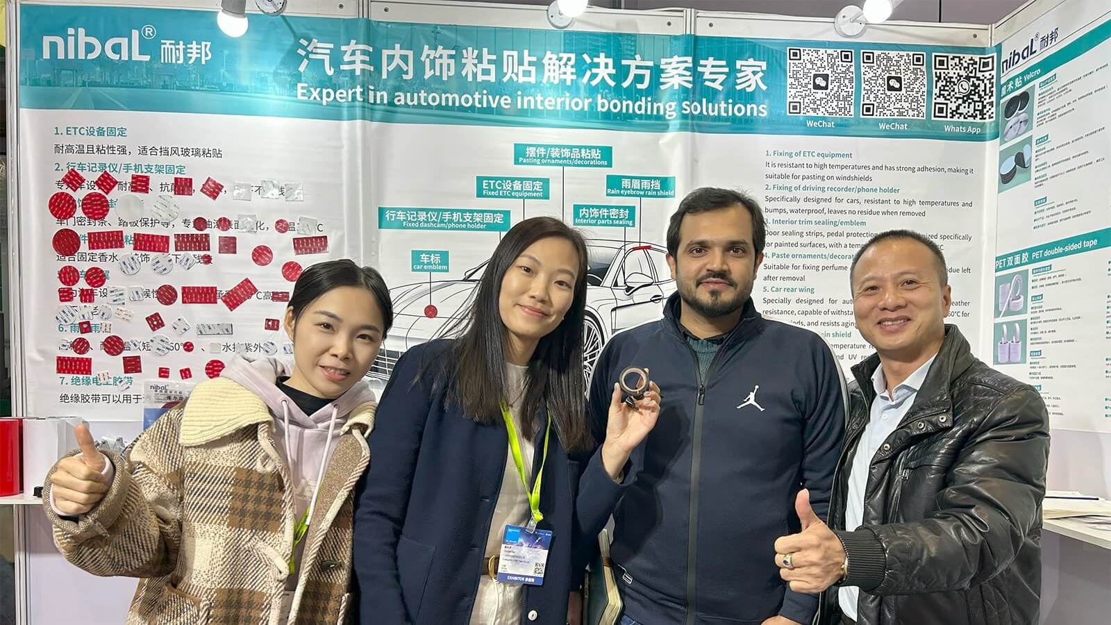 Expo customers reviewing automotive-interior adhesive tape