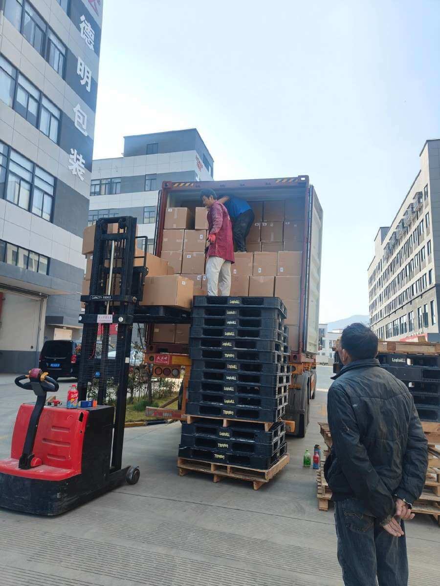 Forklift loading adhesive tape pallets into a container