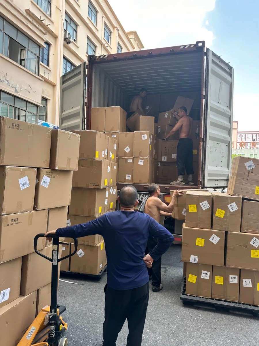 Workers loading custom tape cartons into a shipping container